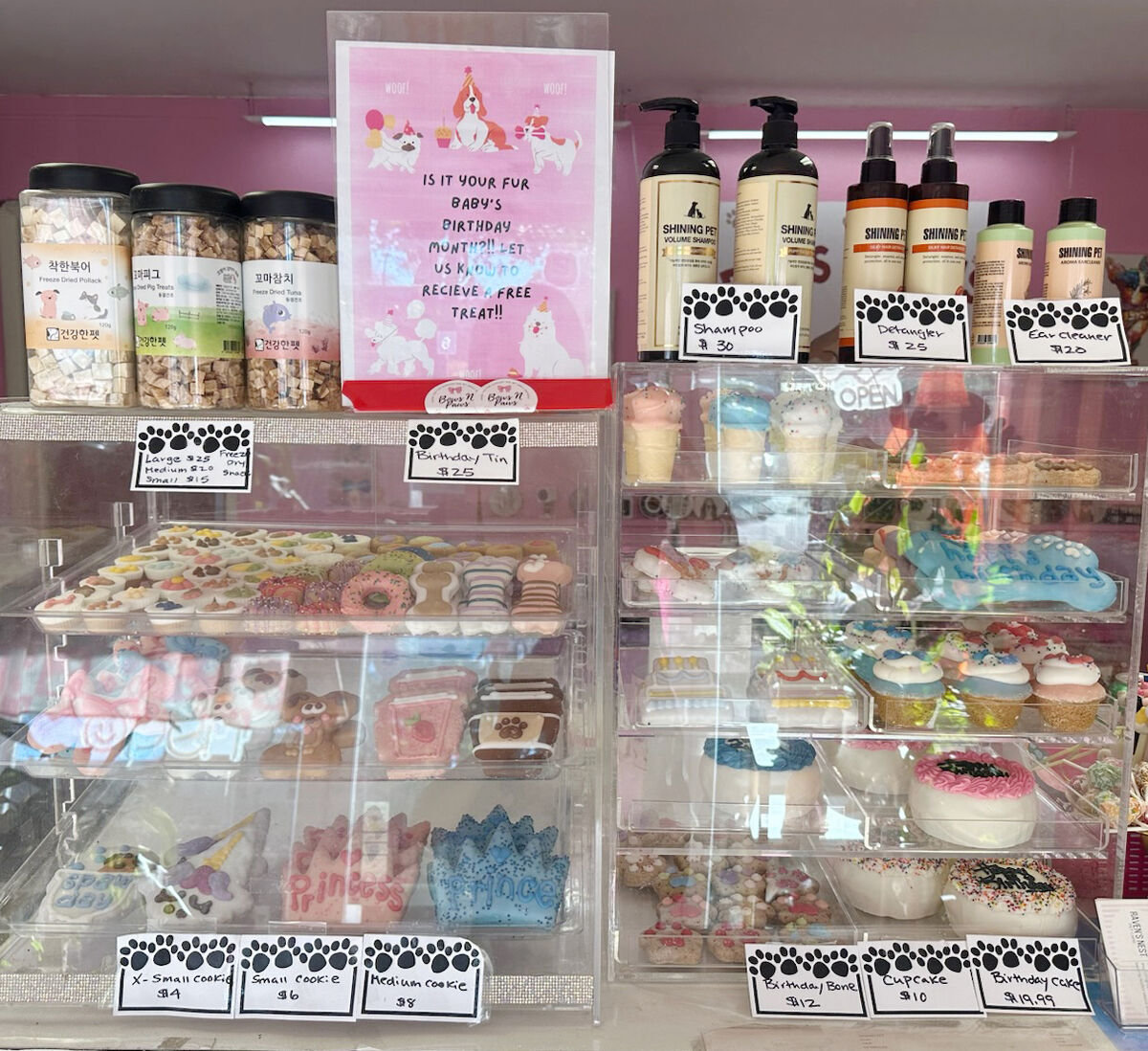 The treat case at Bows N Paws with cookies, cupcakes and birthday bones